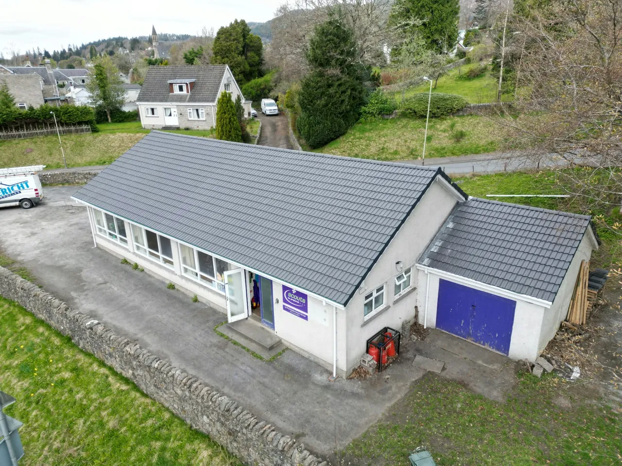 Newly re-roofed scout hall and garage with the Ericht Roofing van parked alongside