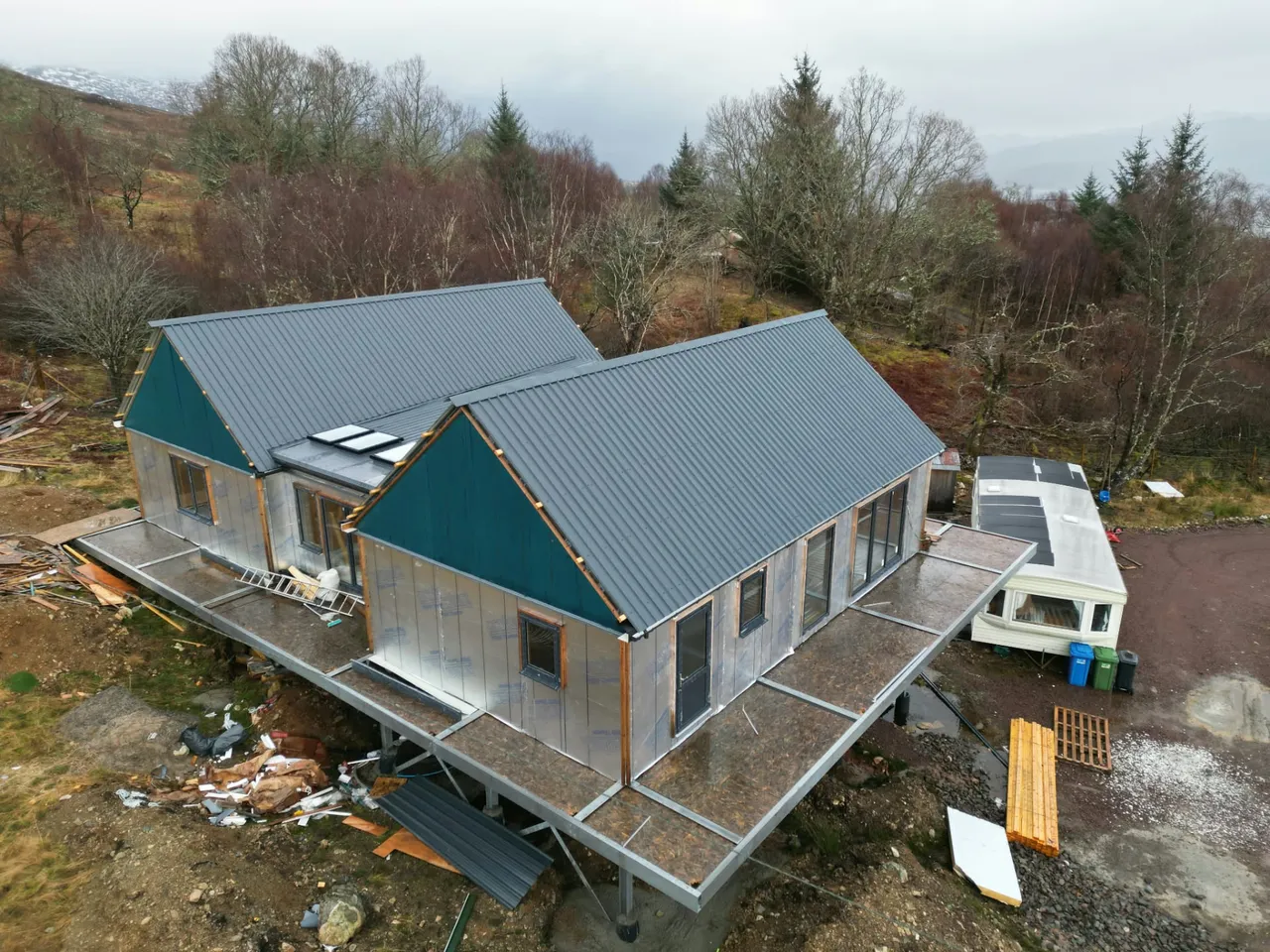 New metal sheet roof on a timber-frame house under construction in the Highlands