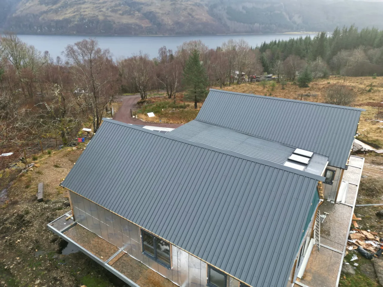 New metal roofing on a new-build house overlooking a loch
