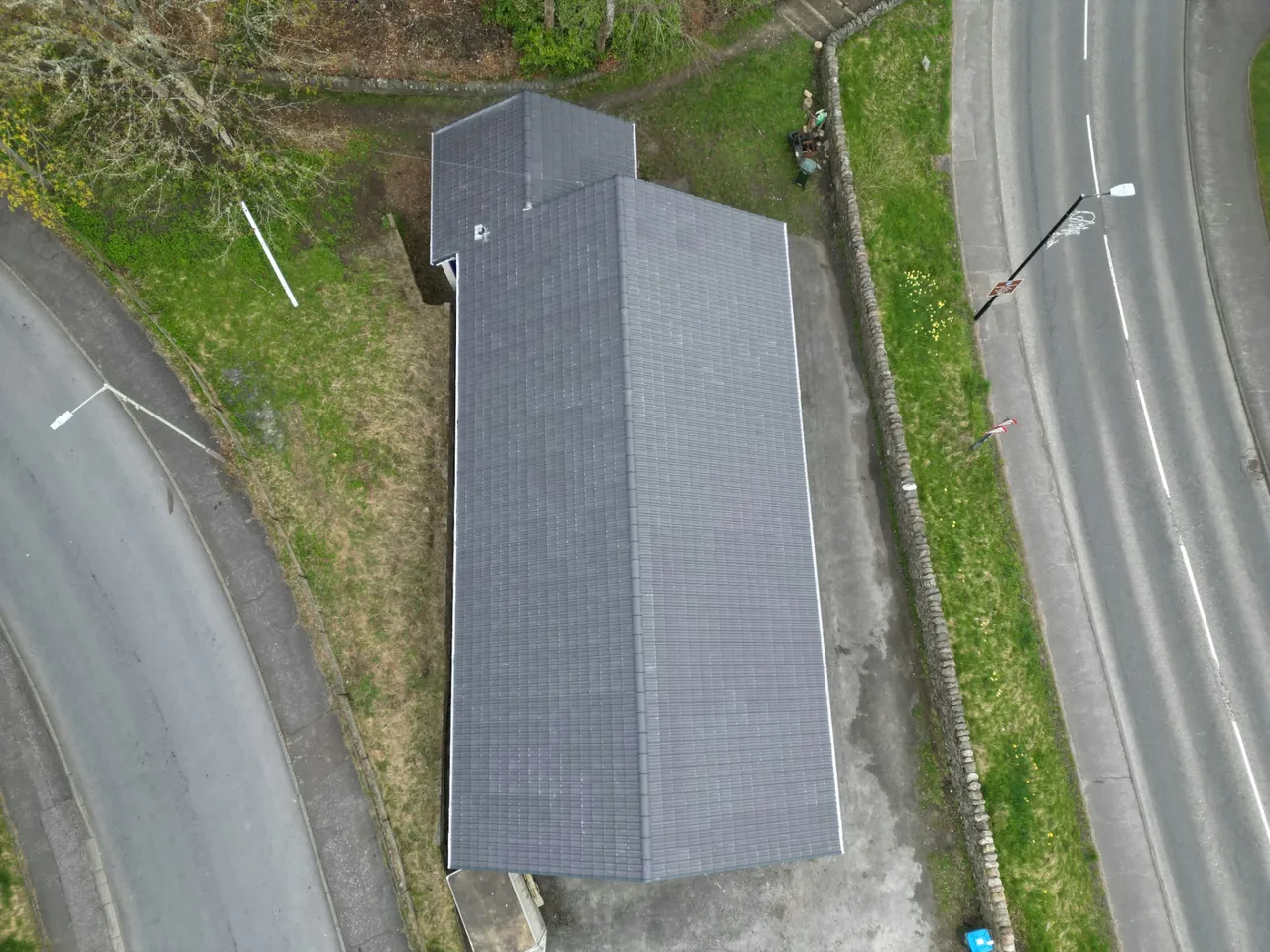 Top-down drone view of a fully re-tiled hall roof